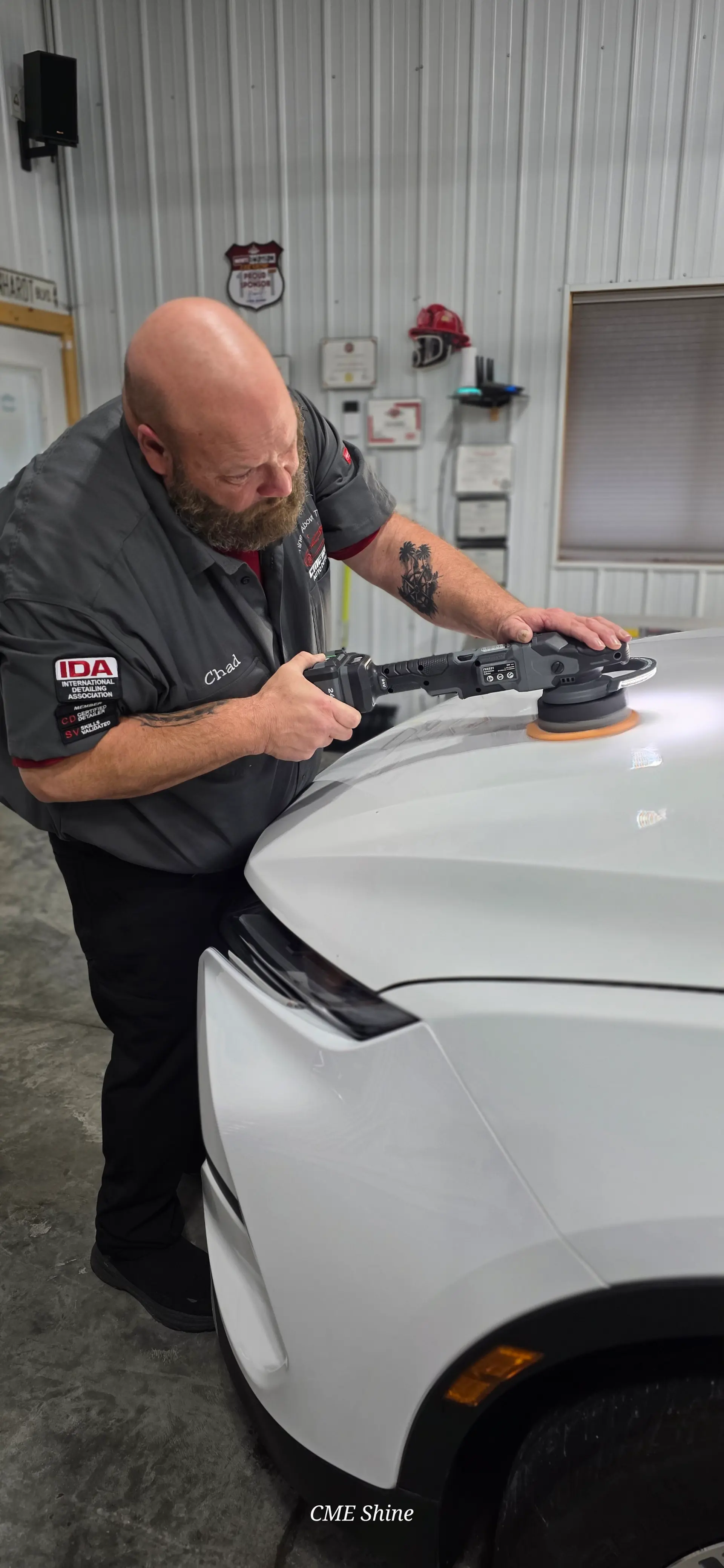 Machine polisher performing paint enhancement on a vehicle panel